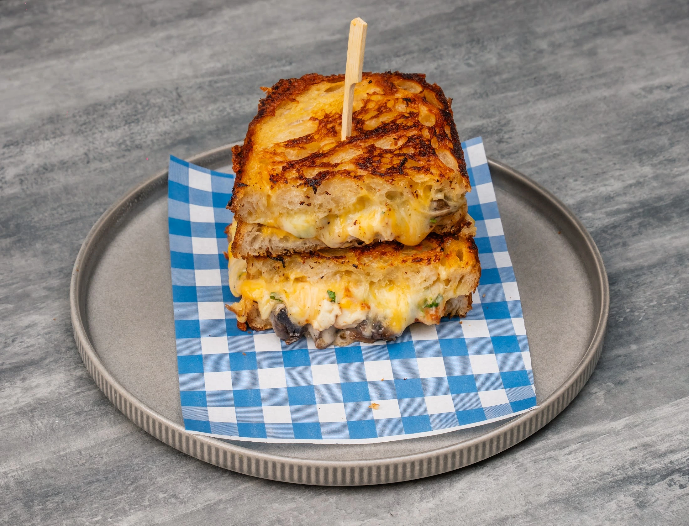 Heart Attack Toastie with smoked beef brisket, bacon, hash brown, onion rings and smoky barbecue sauce on sourdough